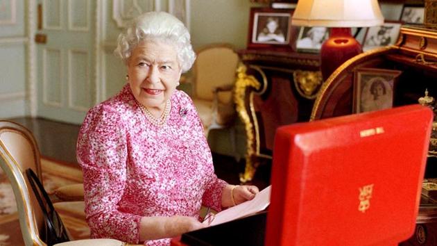 Britain's Queen Elizabeth sits in her private audience room in Buckingham Palace next to one of her official red boxes in which she receives documents and papers from government officials in the United Kingdom and the Commonwealth.(Reuters Photo)