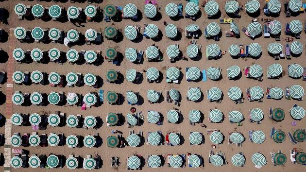 Parasols on a beach of the Adriatic Sea as temperatures rose to 38 degrees Celsius in Albania. (Gent Shkullaku / AFP) Parasols on a beach of the Adriatic Sea as temperatures rose to 38 degrees Celsius in Albania. (Gent Shkullaku / AFP)