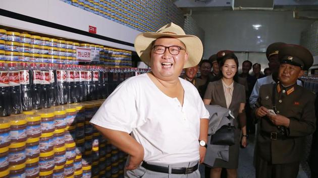 North Korean leader Kim Jong Un (L) inspects the Kumsanpho Fish Pickling Factory with his wife Ri Sol Ju (back C) in South Hwanghae Province, North Korea. (KCNA via KNS / AFP) North Korean leader Kim Jong Un (L) inspects the Kumsanpho Fish Pickling Factory with his wife Ri Sol Ju (back C) in South Hwanghae Province, North Korea. (KCNA via KNS / AFP)