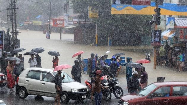 People stranded at a flooded junction following a flash flood, triggered by heavy rains, in Kerala.(PTI File Photo)