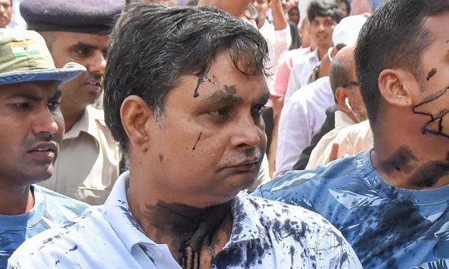 Brajesh Thakur, main accused in the Muzaffarpur shelter home case , after a woman allegedly threw ink on his face while he was being taken to a special POCSO court, in Muzaffarpur on August 8(PTI)