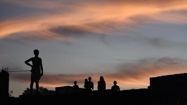 Out in the fields, a group of Thakur men had got into a huddle by then to discuss their next step. The group decided to lie low for a week, until the media and the police left. “Then we shall see what is fit to do done; we will show them we are still the thakurs of the village,” said their leader before walking off in a huff. (Burhaan Kinu / HT Photo) Out in the fields, a group of Thakur men had got into a huddle by then to discuss their next step. The group decided to lie low for a week, until the media and the police left. “Then we shall see what is fit to do done; we will show them we are still the thakurs of the village,” said their leader before walking off in a huff. (Burhaan Kinu / HT Photo)