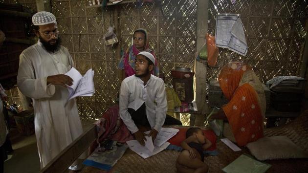 Abdul Mannan (L) just knows a mistake was made somewhere. But what can you say when the authorities suddenly insist one of your five children isn’t an Indian? Or when your wife and daughter-in-law are suddenly viewed as illegal immigrants? “We are genuine Indians. We are not foreigners,” said Mannan, 50, adding his family has lived in Assam since the 1930s. (Anupam Nath / AP)