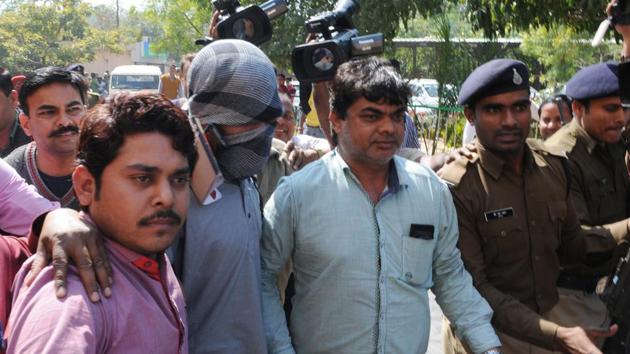 Suspected Islamic State operative, Azhar Iqbal (face covered), was arrested by the NIA in 2016. The central agency has roped in scholars to understand reasons for radicalisation.(HT File Photo)