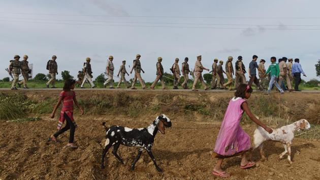 Police personnel inspect an area in the fields where a tent was being erected for the procession. At the negotiation in April, Thakurs refused to give in to Jatav’s demand to ride a horse around the village. So, the officials drew up an alternate route for the baraat that cut halfway through Nizampur. Everyone agreed to it, at last. (Anushree Fadnavis / HT Photo) Police personnel inspect an area in the fields where a tent was being erected for the procession. At the negotiation in April, Thakurs refused to give in to Jatav’s demand to ride a horse around the village. So, the officials drew up an alternate route for the baraat that cut halfway through Nizampur. Everyone agreed to it, at last. (Anushree Fadnavis / HT Photo)