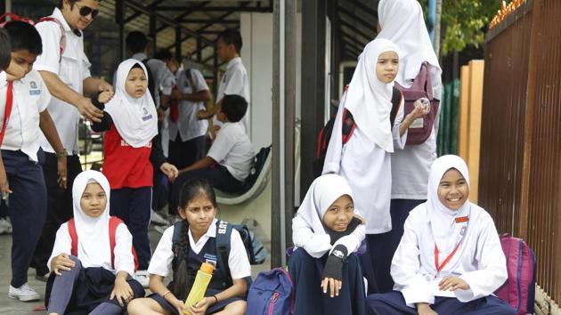 Primary students waited for their parents after school on the outskirts of Kuala Lumpur, Malaysia, Monday, July 2, 2018. Malaysian authorities are investigating the marriage between an 11-year-old Thai girl and a 41-year-old Malaysian Muslim that has sparked public outrage and calls for child brides to be banned. (AP) Primary students waited for their parents after school on the outskirts of Kuala Lumpur, Malaysia, Monday, July 2, 2018. Malaysian authorities are investigating the marriage between an 11-year-old Thai girl and a 41-year-old Malaysian Muslim that has sparked public outrage and calls for child brides to be banned. (AP)