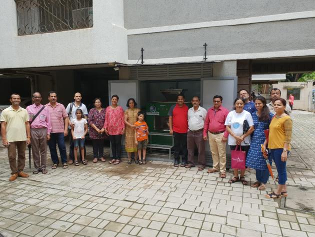 Residents of Anchorage Co-operative Housing Society in Borivli (West) stand next to their organic waste composter (OWC) machine.(HT PHOTO)