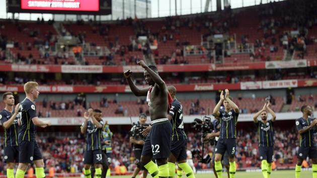 Manchester City players celebrate at the end of the English Premier League soccer match between Arsenal and Manchester City at the Emirates stadium in London.(AP)