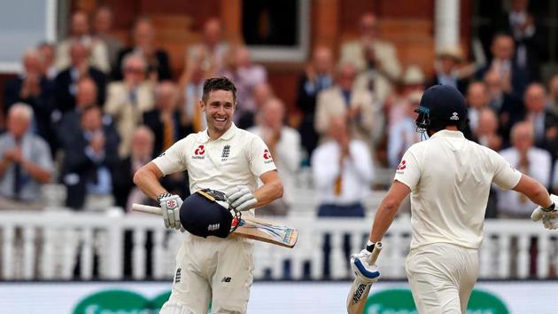 England's batsman Chris Woakes (L) turns to his batting partner Jonny Bairstow (R) as he celebrates scoring his century on the third day of the second Test cricket match between England and India at Lord's Cricket Ground in London on August 11, 2018 (AFP)