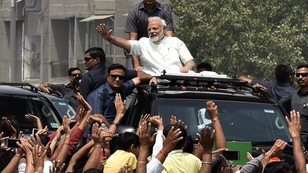 Prime Minister Narendra Modi waves to supporters during a road show after inaugurating the Delhi-Meerut National expressway in New Delhi on May 27, 2018. The PM said he looks forward Independence Day celebrations on Wednesday, but the occasion should become more than a ‘platform’ to launch programmes.(Sonu Mehta/HT File Photo)