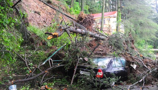 A car is seen buried under the debris after heavy rains triggered a landslide at Jakhoo, Shimla on Monday. (Deepak Sansta /HT Photo) A car is seen buried under the debris after heavy rains triggered a landslide at Jakhoo, Shimla on Monday. (Deepak Sansta /HT Photo)
