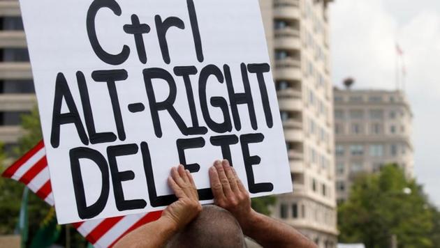 A man holds a banner as people gather at Freedom Plaza to protest the white nationalist Unite the Right rally in downtown Washington. (Reuters) A man holds a banner as people gather at Freedom Plaza to protest the white nationalist Unite the Right rally in downtown Washington. (Reuters)