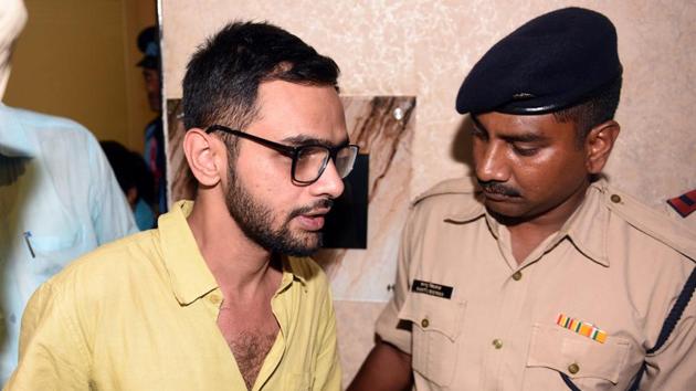 Delhi Police personnel with Umar Khalid, who escaped unhurt after an unidentified man shot at him, outside the Constitution Club in New Delhi. (Sonu Mehta/HT Photo) Delhi Police personnel with Umar Khalid, who escaped unhurt after an unidentified man shot at him, outside the Constitution Club in New Delhi. (Sonu Mehta/HT Photo)