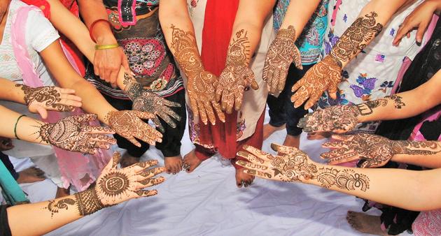 Women in Delhi-NCR get their hands beautified with mehendi, for Teej celebrations.