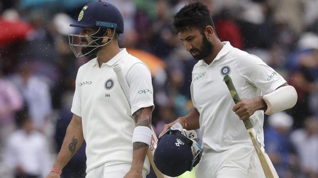 Virat Kohli, left, and Cheteshwar Pujara leave the pitch as rain stops play during the Lord’s Test against England. (AP) Virat Kohli, left, and Cheteshwar Pujara leave the pitch as rain stops play during the Lord’s Test against England. (AP)