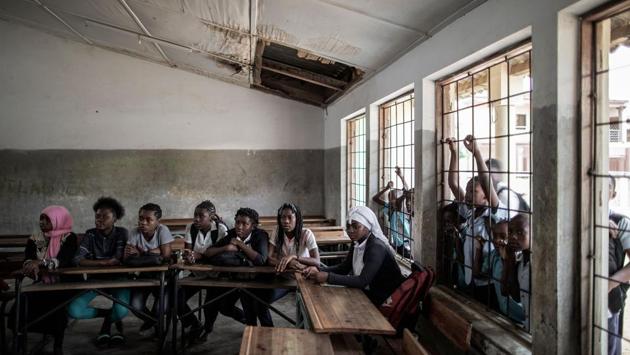 Mozambican girls listen to a contraception methods and sexual education briefing at a public school. “My parents really wanted me to get married,” said Julia Afonso, one of the girls who had just given birth in Murrupelane, a village in the north. In a tiny voice, she said her family received 1,500 meticals (USD 21) as a dowry. (Gianluigi Guercia / AFP) Mozambican girls listen to a contraception methods and sexual education briefing at a public school. “My parents really wanted me to get married,” said Julia Afonso, one of the girls who had just given birth in Murrupelane, a village in the north. In a tiny voice, she said her family received 1,500 meticals (USD 21) as a dowry. (Gianluigi Guercia / AFP)