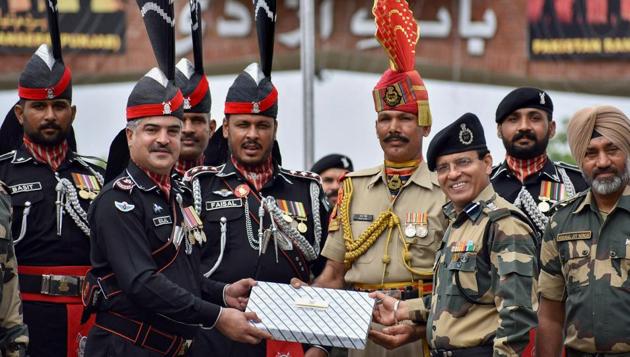 Pakistani Wing Commander Bilal Ahmed (L) presents sweets to Border Security Force (BSF) Commandant, Sudeep Kumar, on the Independence Day of Pakistan at the India-Pakistan Attari-Wagah border post about 35 km from Amritsar on Tuesday. (PTI) Pakistani Wing Commander Bilal Ahmed (L) presents sweets to Border Security Force (BSF) Commandant, Sudeep Kumar, on the Independence Day of Pakistan at the India-Pakistan Attari-Wagah border post about 35 km from Amritsar on Tuesday. (PTI)