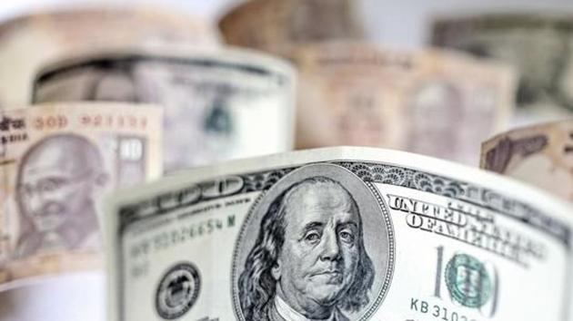 US dollar bills and Indian ten rupee banknotes are arranged for a photograph in Mumbai. (Bloomberg) US dollar bills and Indian ten rupee banknotes are arranged for a photograph in Mumbai. (Bloomberg)