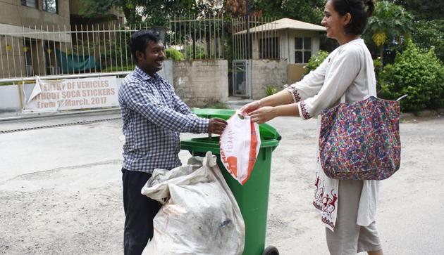 Bags of trash being deposited with a garbage collection man in Gurugram.(Yogendra Kumar/HT Photo)