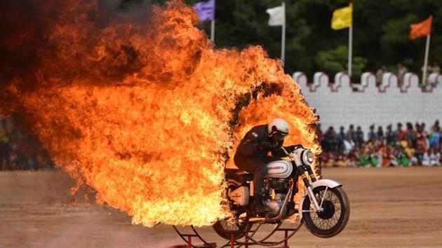A member of ASC Tornados, the motorcycle display team of the Indian Army, jumps through a ring of fire as he performs a stunt display during Indian Independence Day celebrations in Bengaluru. (Arijit Sen / HT Photo)