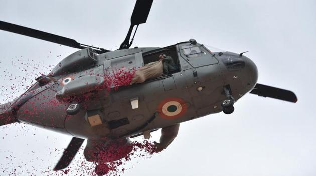 Indian Air Force personnel seen showering rose petals from a helicopter during Independence Day celebrations at Manekshaw Parade ground in Bengaluru. (Arijit Sen / HT Photo)