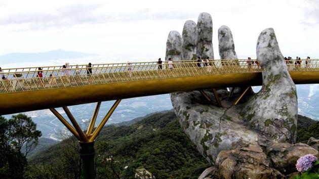 Golden Bridge, Vietnam: The “Golden Bridge” in Vietnam has attracted hordes of guests since it opened in the Ba Na Hills near Danang in June. It is designed to make visitors feel like they’re taking a stroll on a shimmering thread stretching across the hands of gods. (AFP) Golden Bridge, Vietnam: The “Golden Bridge” in Vietnam has attracted hordes of guests since it opened in the Ba Na Hills near Danang in June. It is designed to make visitors feel like they’re taking a stroll on a shimmering thread stretching across the hands of gods. (AFP)