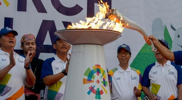 Officials light the 2018 Asian Games torch during the torch relay in Jakarta.(AFP)