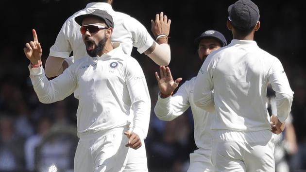 Virat Kohli celebrates as India's Ishant Sharma takes the wicket of England's Alastair Cook at Lord’s.(AP)