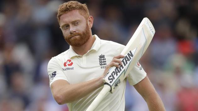 England's Jonny Bairstow holds up his bat to applause as he leaves the pitch after he is caught by India's Dinesh Karthik during the third day of the second test match between England and India at Lord's.(AP)