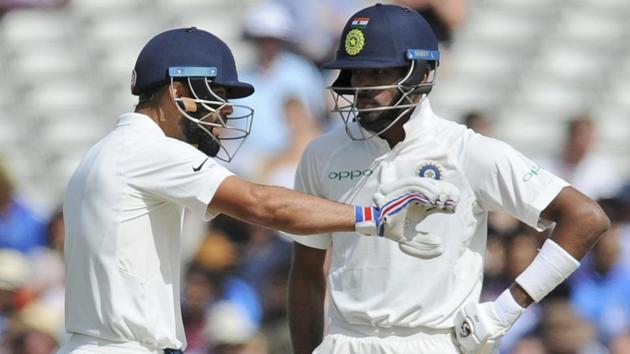 Indian cricket captain Virat Kohli, left, speaks with Hardik Pandya during the fourth day of the first Test against England.(AP)