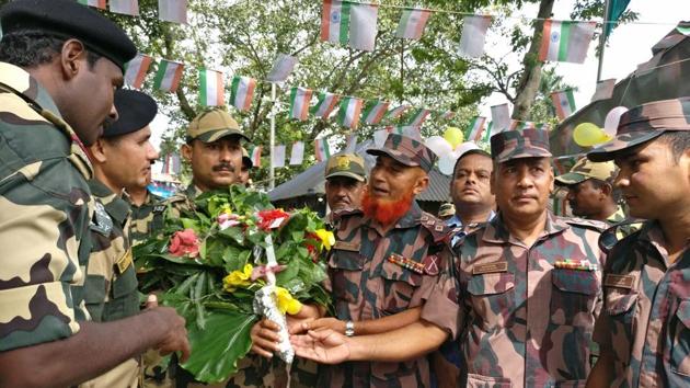 Border Guard of Bangladesh (BGB) officials greet Border Security Force (BSF) personnel on the occasion of India’s Independence Day at the international border checkpost in Hili near Balurghat in South Dinajpur district of West Bengal. (PTI)