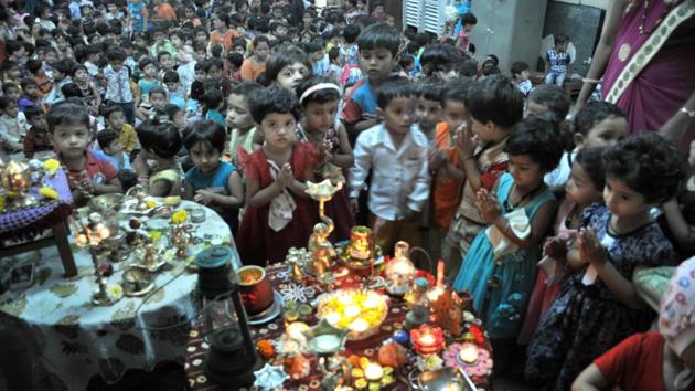 Children get together to pray by lighting various types of lamps on the auspicious occasion of Deep Amavasya which is celebrated ahead of Ashada Amavasya at Ranade Balak Mandir on Friday. (HT PHOTO) 
