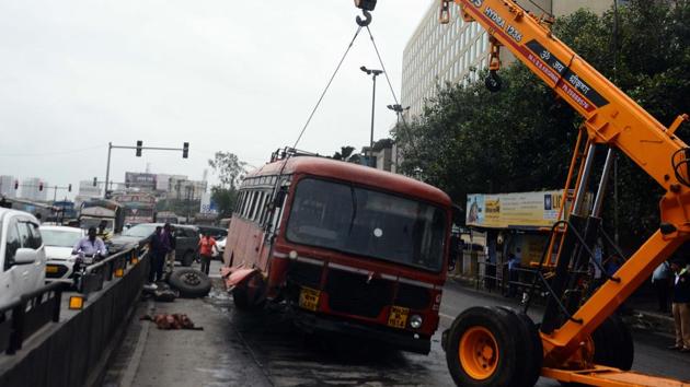 On Sunday, a Bus rapid transport system bus (BRTS), going towards Beed, collided with a divider at Wadgaon sheri, after its  steering failed. No casualties were reported. The incident took place at 6am. Later, with the help of a crane, the bus was set aside by authorities to avoid traffic suggestion.  (Shankar Narayan/HT PHOTO) 