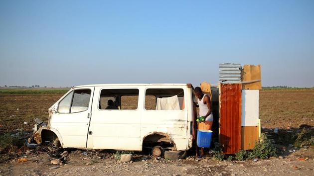 An African migrant labourer gets out of the shower box outside the camp known as the “Great Ghetto”, near Foggia. The multiple deaths come at a time of rising anti-immigration sentiment in Italy, with the newly installed government moving to halt the migrant arrivals to the country and promising mass deportations for those already here, no closer to integrating into local society than the day they arrived by boat from Libya. (Alessandro Bianchi / REUTERS) 