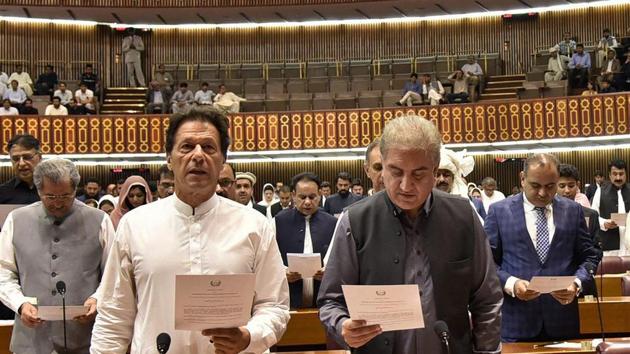 Newly elected parliamentarian Imran Khan, left, takes the oath of office with Shah Mehmood Qureshi, in Islamabad, Pakistan.(AP Photo)