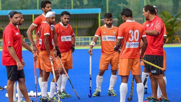 File photo of Indian men’s hockey team players with coach Harendra Singh during a practice session.(PTI)