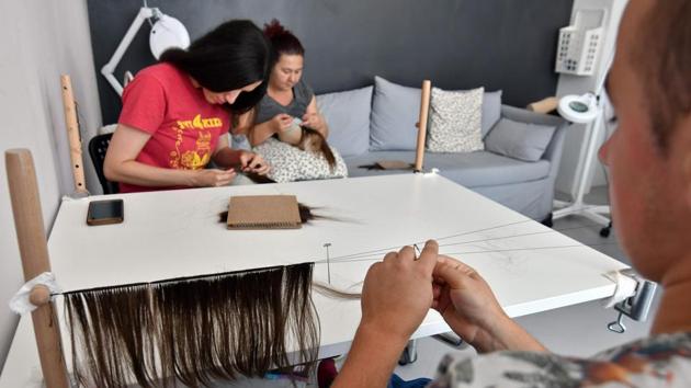 Hundreds of people -- mainly women, as the hair must be at least 30 centimetres (12 inches) long -- have flocked to hair-cutting events held at schools and shopping malls around the country. Others have cut their own hair and mailed it to the campaign. “I don’t want to be the only one smiling,” said 13-year-old Suana Sehic, now sporting a bouncy bob. (Elvis Barukcic / AFP) 