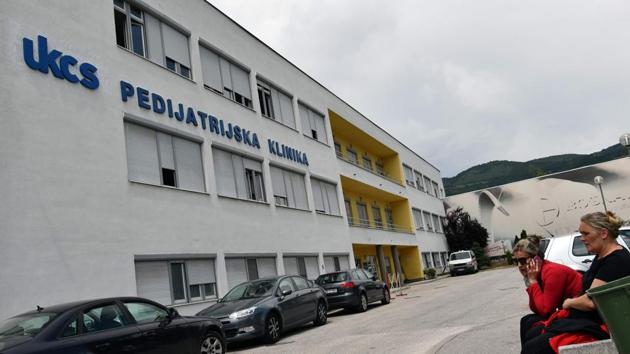 People sit outside the paediatric hospital in Sarajevo. The project is part of a wider effort by an association called “A Heart for Children with Cancer” which helps young patients and their families. In 2016, the group opened Bosnia’s first “Parents’ House” -- a small apartment complex near the hospital where families who live far from the capital can stay while their children are being treated. (Elvis Barukcic / AFP) 