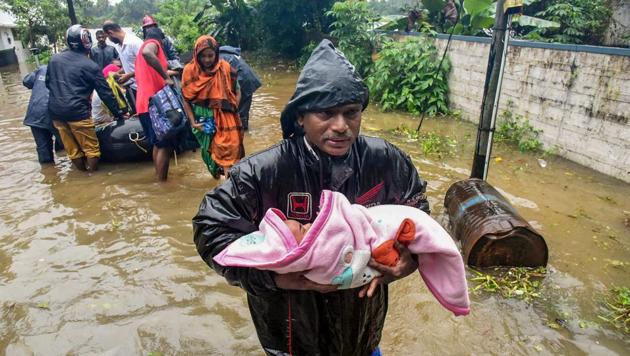 A rescuer carries an infant as people are evacuated from a flood-hit locality in Kochi on August 15, 2018. The Indian Air Force launched rescue operations in Pathanamthitta district which is one of the worst affected places and winched people to safety. The Indo-Tibetan Border Police (ITBP) is also in action in Thrissur district, rescuing people from flooded areas. (PTI) A rescuer carries an infant as people are evacuated from a flood-hit locality in Kochi on August 15, 2018. The Indian Air Force launched rescue operations in Pathanamthitta district which is one of the worst affected places and winched people to safety. The Indo-Tibetan Border Police (ITBP) is also in action in Thrissur district, rescuing people from flooded areas. (PTI)