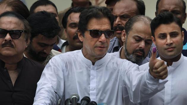 Imran Khan shows his marked thumb after casting his vote at a polling station for the parliamentary elections in Islamabad.(AP File photo)