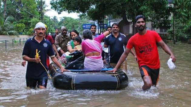 Volunteers and rescue personnel evacuate local residents in a boat in a residential area at Kozhikode, in the Indian state of Kerala, on August 16, 2018.(AFP) Volunteers and rescue personnel evacuate local residents in a boat in a residential area at Kozhikode, in the Indian state of Kerala, on August 16, 2018.(AFP)
