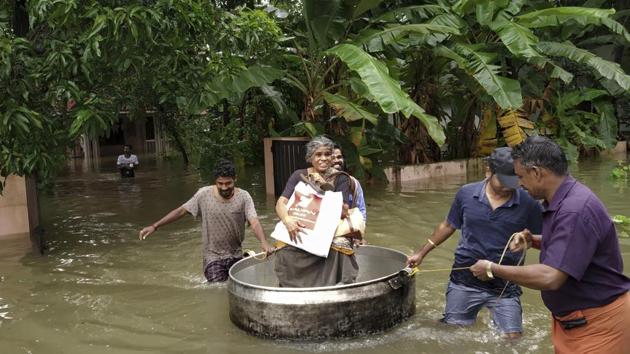 An elderly woman is rescued in a cooking utensil after her home was flooded in Thrissur, Kerala, on August 16, 2018. The torrential rains in Kerala have left over 30,000 people homeless, killed more than 160, destroyed crops and disrupted air, rail and road traffic within the state for a week. Different studies, however, have found that climate change and deforestation were the main causes of an increase in rainfall. (K.K. Najeeb / AP) An elderly woman is rescued in a cooking utensil after her home was flooded in Thrissur, Kerala, on August 16, 2018. The torrential rains in Kerala have left over 30,000 people homeless, killed more than 160, destroyed crops and disrupted air, rail and road traffic within the state for a week. Different studies, however, have found that climate change and deforestation were the main causes of an increase in rainfall. (K.K. Najeeb / AP)