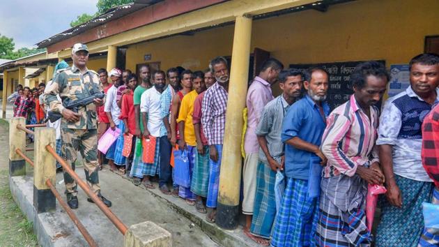 People wait in a queue to check their names on the final draft of the state's National Register of Citizens after it was released, at an NRC Seva Kendra, in Morigaon on Monday, July 30, 2018.(PTI)