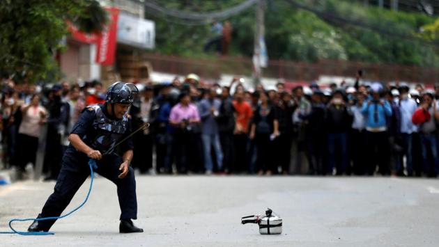 A member of Nepalese police checks a pressure cooker suspected of being an improvised bomb during a bomb scare in Lalitpur, Nepal. The scare was later found to be a false alarm. (Navesh Chitrakar / REUTERS) A member of Nepalese police checks a pressure cooker suspected of being an improvised bomb during a bomb scare in Lalitpur, Nepal. The scare was later found to be a false alarm. (Navesh Chitrakar / REUTERS)