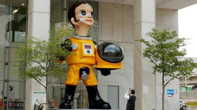 A woman takes a picture of a controversial statue of a child wearing what appears to be a hazardous material suit in Fukushima, Japan. (Kwiyeon Ha / REUTERS) A woman takes a picture of a controversial statue of a child wearing what appears to be a hazardous material suit in Fukushima, Japan. (Kwiyeon Ha / REUTERS)