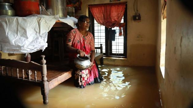 A woman sits inside her house immersed in flood waters in Ernakulam district on August 10, 2018. “It is the worst calamity after the 1924 deluge. At least 443 villages in the state were declared flood-hit. Initial loss is pegged at Rs 8, 316 crore and the amount will go up once we get a clear picture,” said chief minister Pinarayi Vijayan after a cabinet meeting where it was also decided to set up a subcommittee to oversee relief operations. (AFP Photo) A woman sits inside her house immersed in flood waters in Ernakulam district on August 10, 2018. “It is the worst calamity after the 1924 deluge. At least 443 villages in the state were declared flood-hit. Initial loss is pegged at Rs 8, 316 crore and the amount will go up once we get a clear picture,” said chief minister Pinarayi Vijayan after a cabinet meeting where it was also decided to set up a subcommittee to oversee relief operations. (AFP Photo)