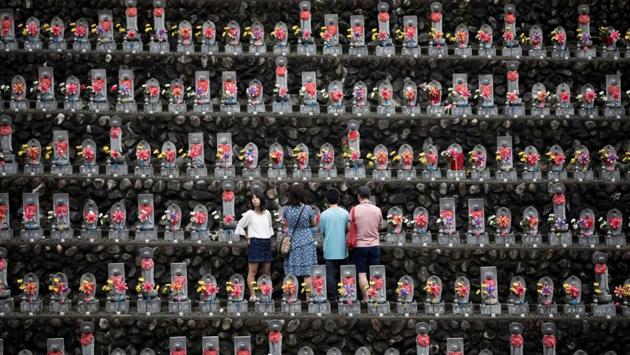 A family pays respects in front of jizo statues in Jizoji Buddhist Temple in Oganomachi, Saitama prefecture, for the souls of unborn children and those who died at a young age, during the Obon prayers period. (Behrouz Mehri / AFP) A family pays respects in front of jizo statues in Jizoji Buddhist Temple in Oganomachi, Saitama prefecture, for the souls of unborn children and those who died at a young age, during the Obon prayers period. (Behrouz Mehri / AFP)