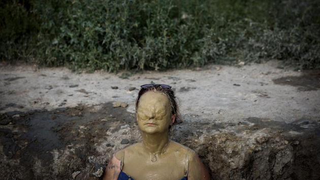 A woman covered with mud sunbathes in Ovca, near Belgrade as a heatwave sweeps across Europe. (Oliver Bunic / AFP) A woman covered with mud sunbathes in Ovca, near Belgrade as a heatwave sweeps across Europe. (Oliver Bunic / AFP)