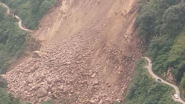 Massive landslide blocked the road at a village in Himachal Pradesh’s Rampur on Saturday.(HT Photo)