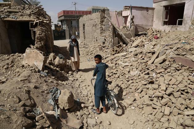 Afghan residents walk near destroyed houses after a Taliban attack in Ghazni on August 16, 2018. (AFP) Afghan residents walk near destroyed houses after a Taliban attack in Ghazni on August 16, 2018. (AFP)